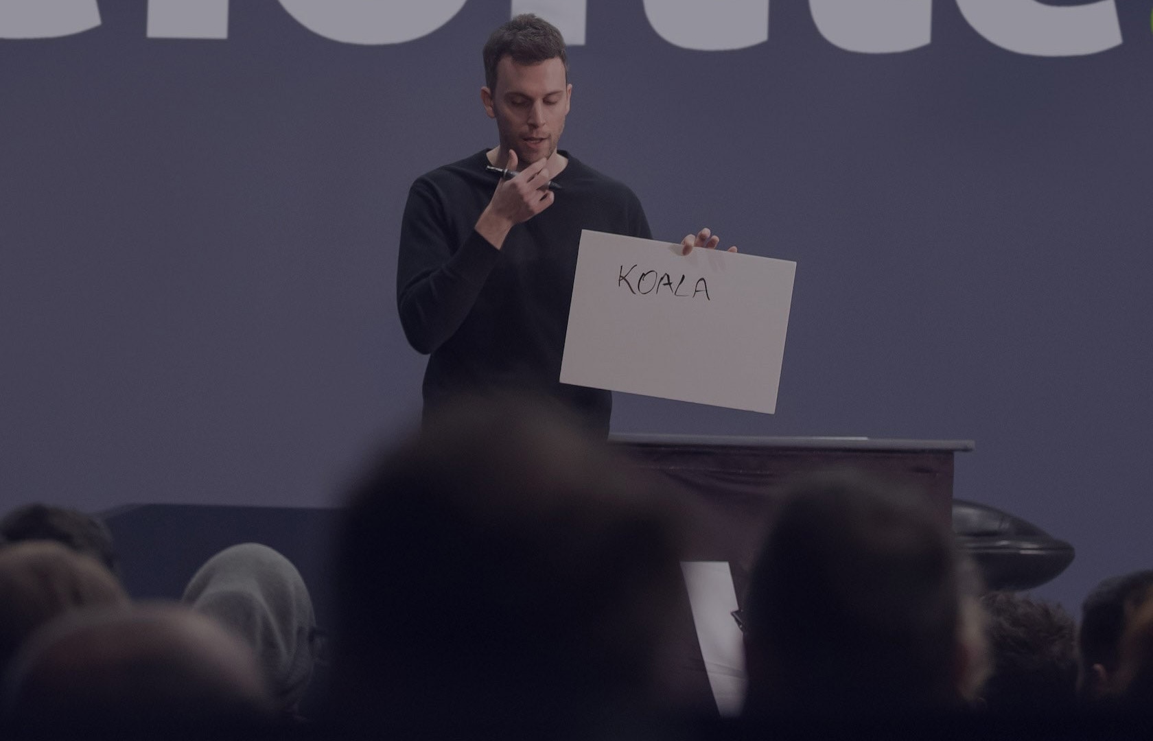 Marc performing close-up magic surrounded by guests