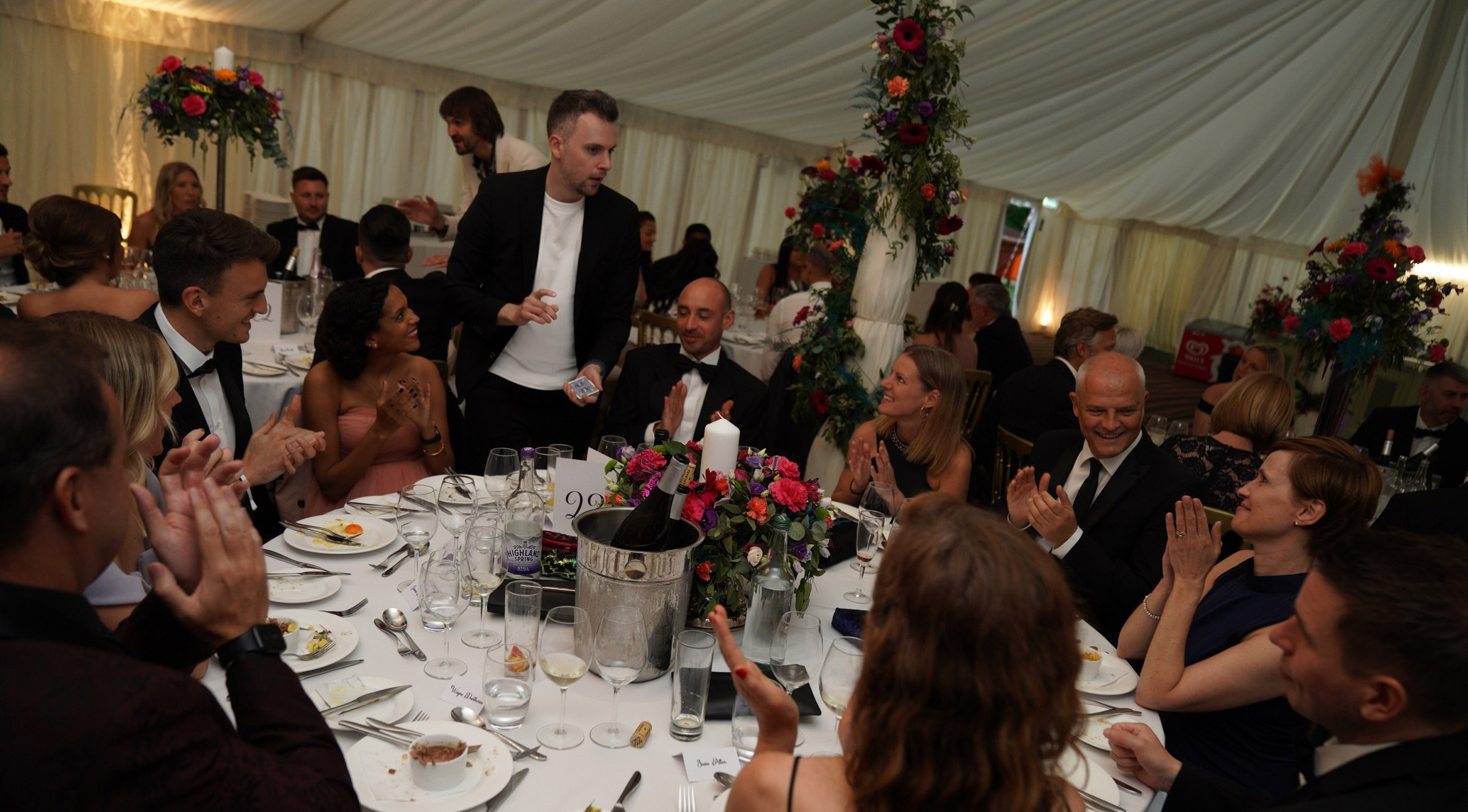 Wedding guests applauding after Marc's close-up magic